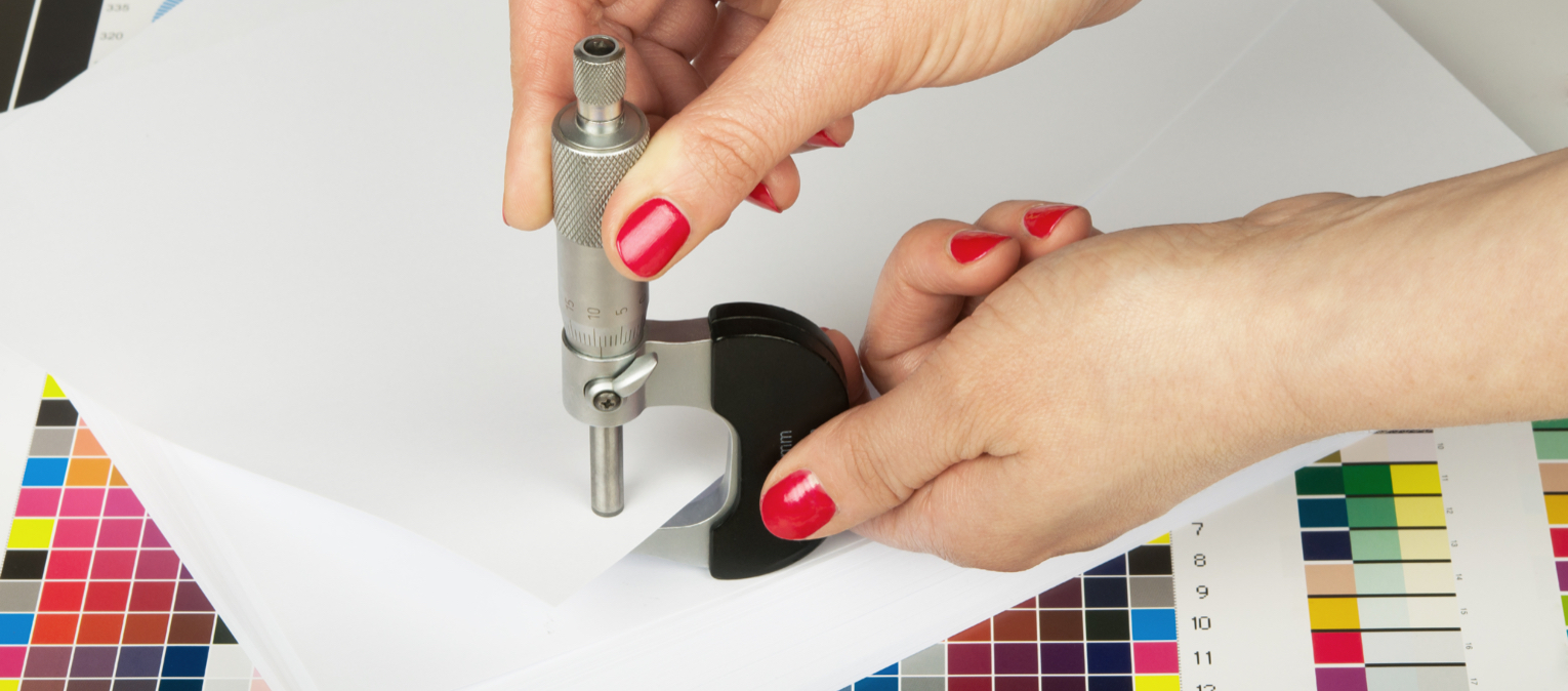 A printer works on the design of a custom mailer.