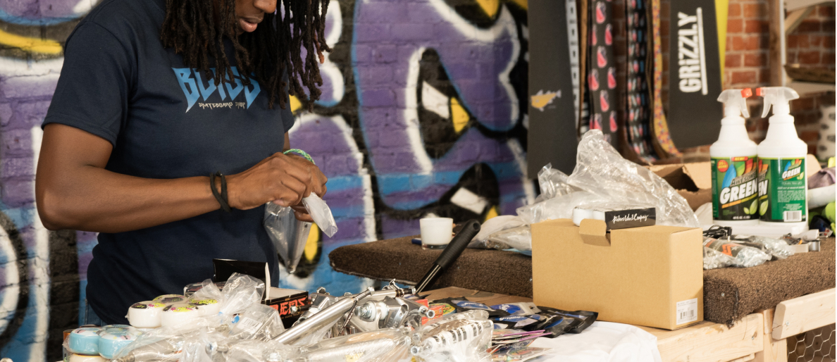 Bliss Skateboard Shop owner, Sasha Senior unpacks a box of skateboard parts. 