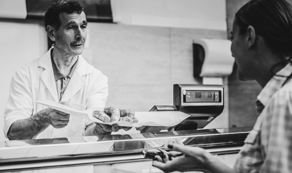 A butcher serving a customer.