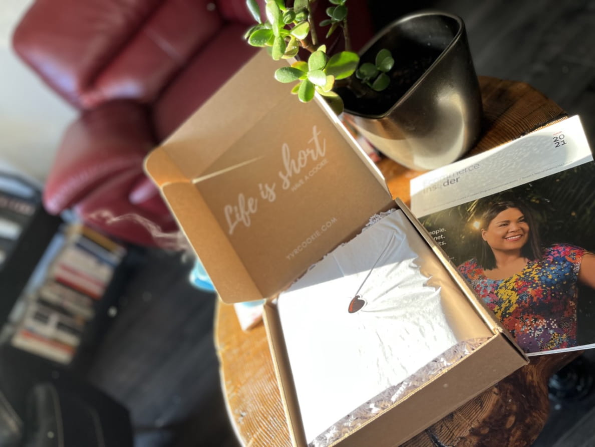 A copy of Ecommerce Insider magazine next to a box of YVR cookies. The box says, “Life is short have a cookie.”