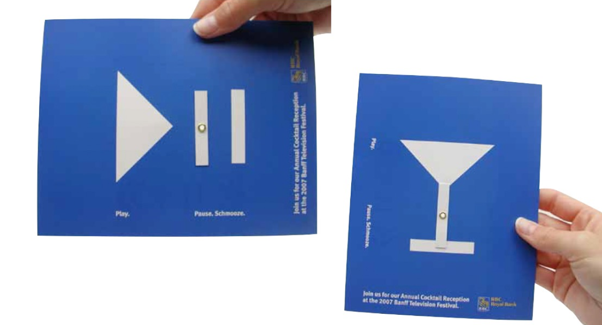 Someone shows off RBC’s direct mail postcard which features a play and pause symbol on a blue postcard. When folded, it rearranges to look like a martini glass. 