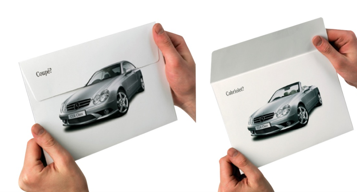 Someone holds the envelope for Mercedes’ direct mail campaign. The closed envelope shows a silver new car model, the open envelope shows the same car as a convertible.