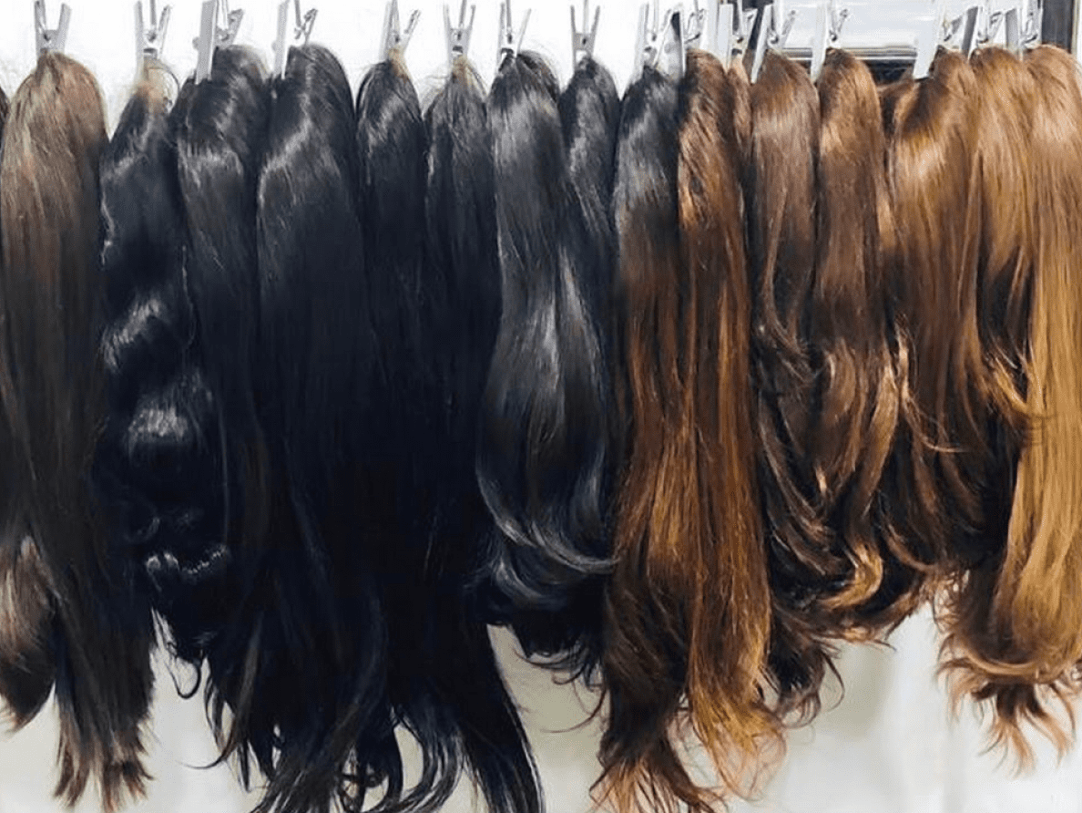 A row of long shiny wigs from Kapenzo Hair.