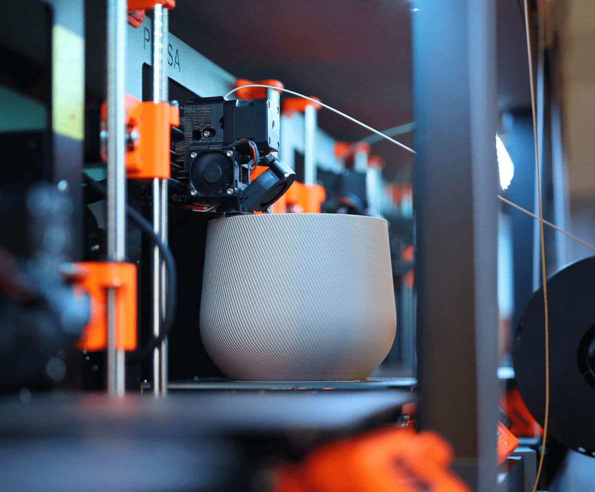 A 3D printer creates a beige plant pot for Conifer Homewares.