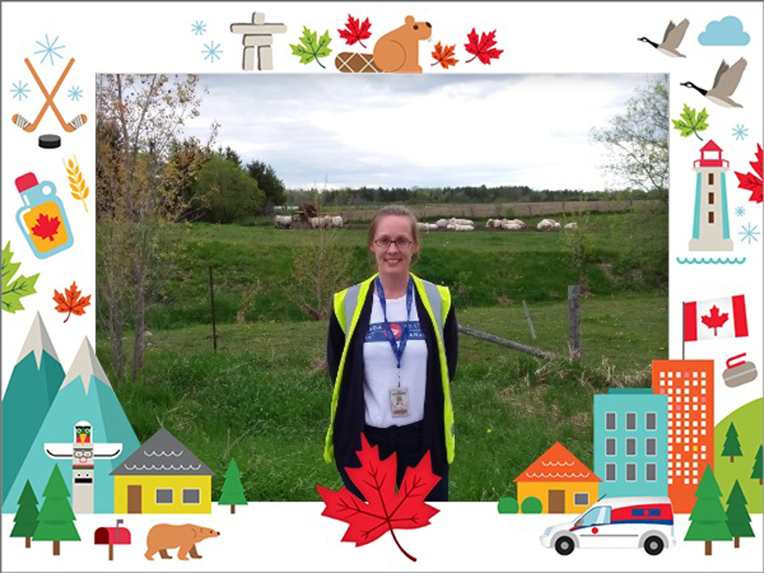 Canada Post employee posing in rural community.