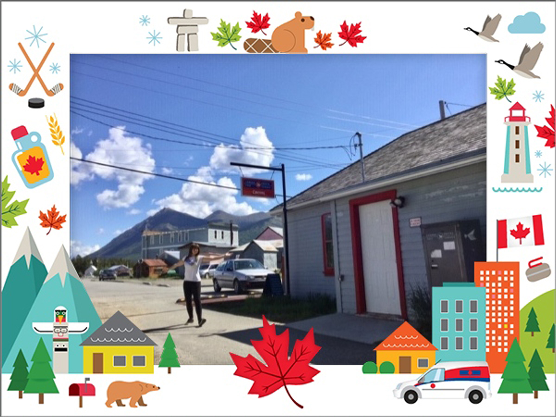 Photo of a Canada Post employee in fron of the post office in Carcross, Yukon.