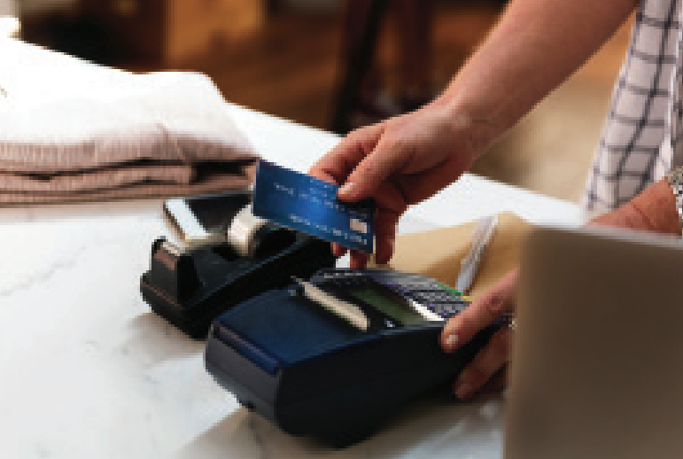A customer about to use their debit card in a point-of-sale machine
