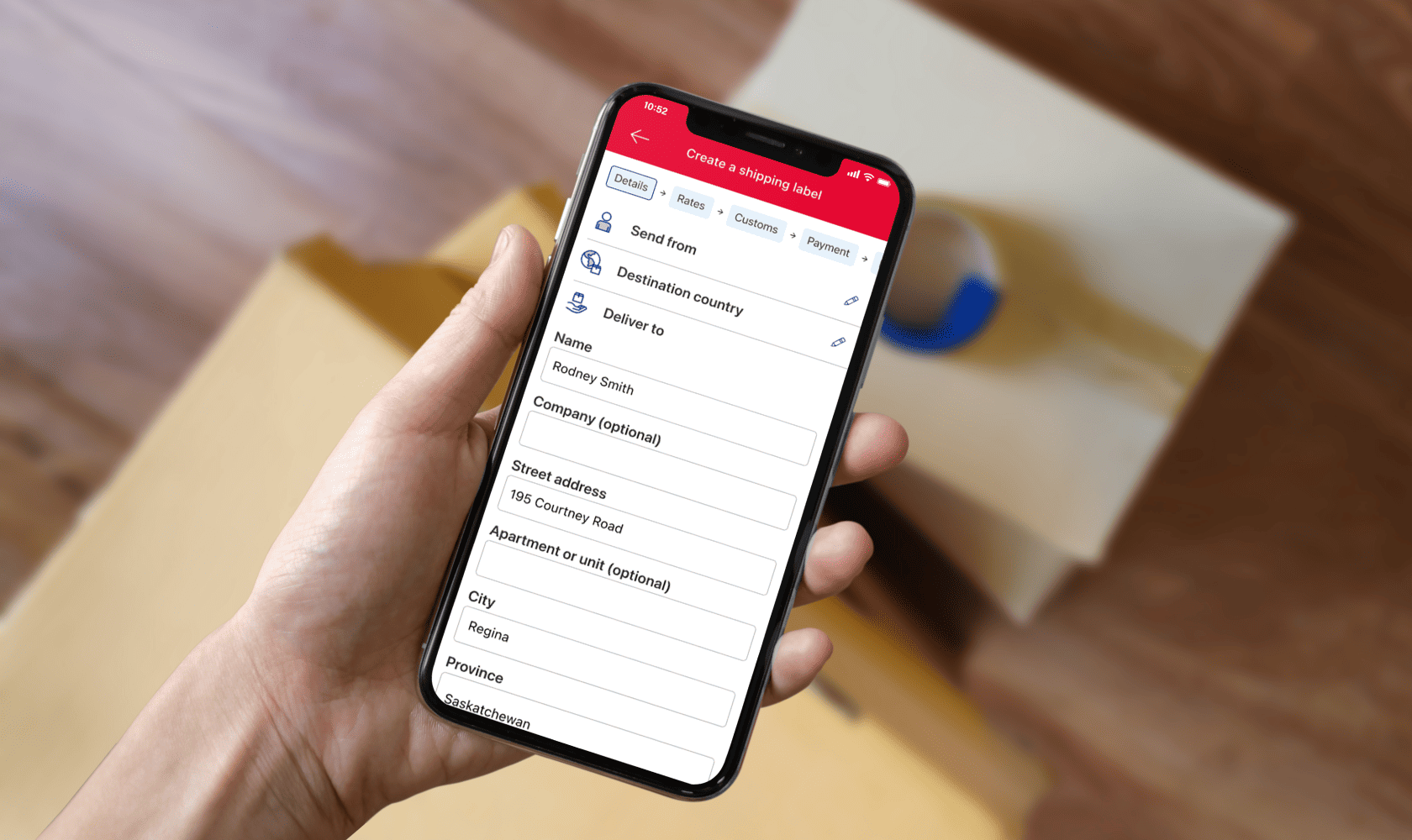 A smartphone displays the Canada Post app “Create a shipping label” page with sender, destination country and address fields.