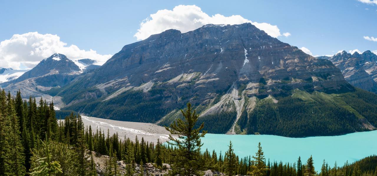A glacial lake surrounded by green mountains.