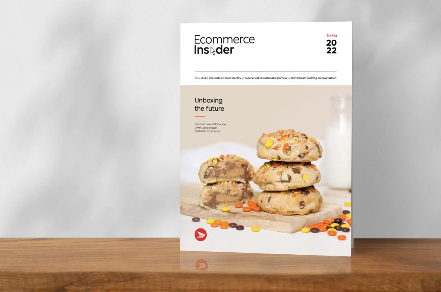 The cover of the spring 2022 edition of Ecommerce Insider magazine features a stack of YVR Cookie Co. cookies.