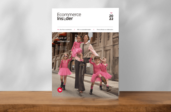 The cover of a past issue of Ecommerce Insider magazine features a chic young woman and three children who wear matching pink outfits and stand on a street together.