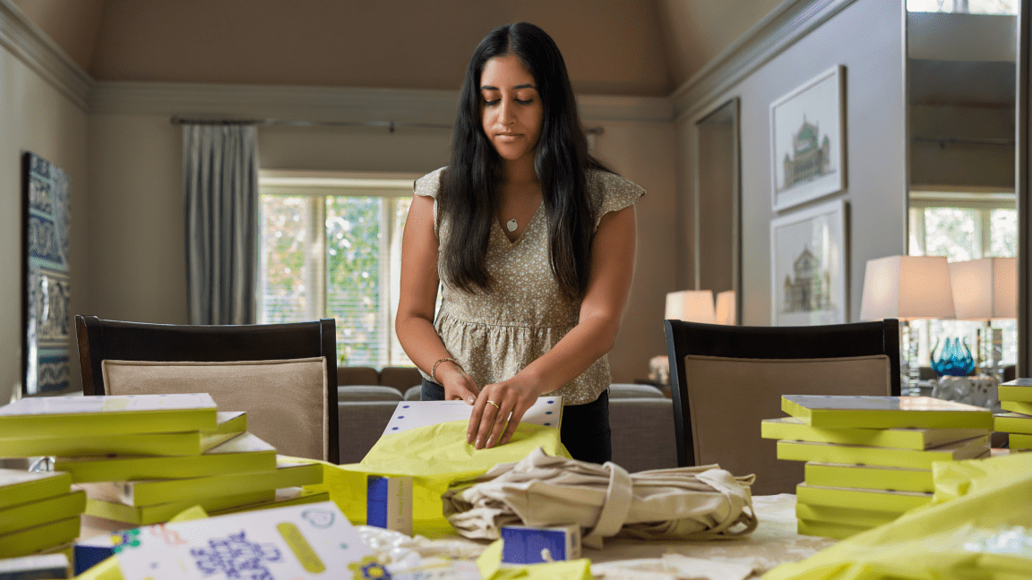 Nadia Ladak, one of the 4 co-founders of Marlow, fills orders standing at a dining room table.