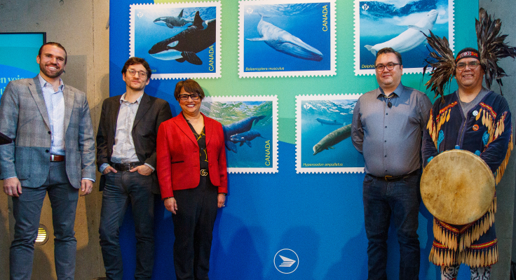 Joshua Ford, Canada Post's Director of Regional Process Engineering; Dr. Thomas Doniol-Valcroze, Fisheries and Oceans Canada; Suromitra Sanatani, Chair of the Board of Directors of Canada Post; Morgan Guerin, Senior Marine Planning Specialist and Marine Enforcement Coordinator for the Musqueam First Nation; and Alec Dan of the Musqueam First Nation at the unveiling for the Endangered Whales stamps at Vancouver's Beaty Biodiversity Museum in May 2022.