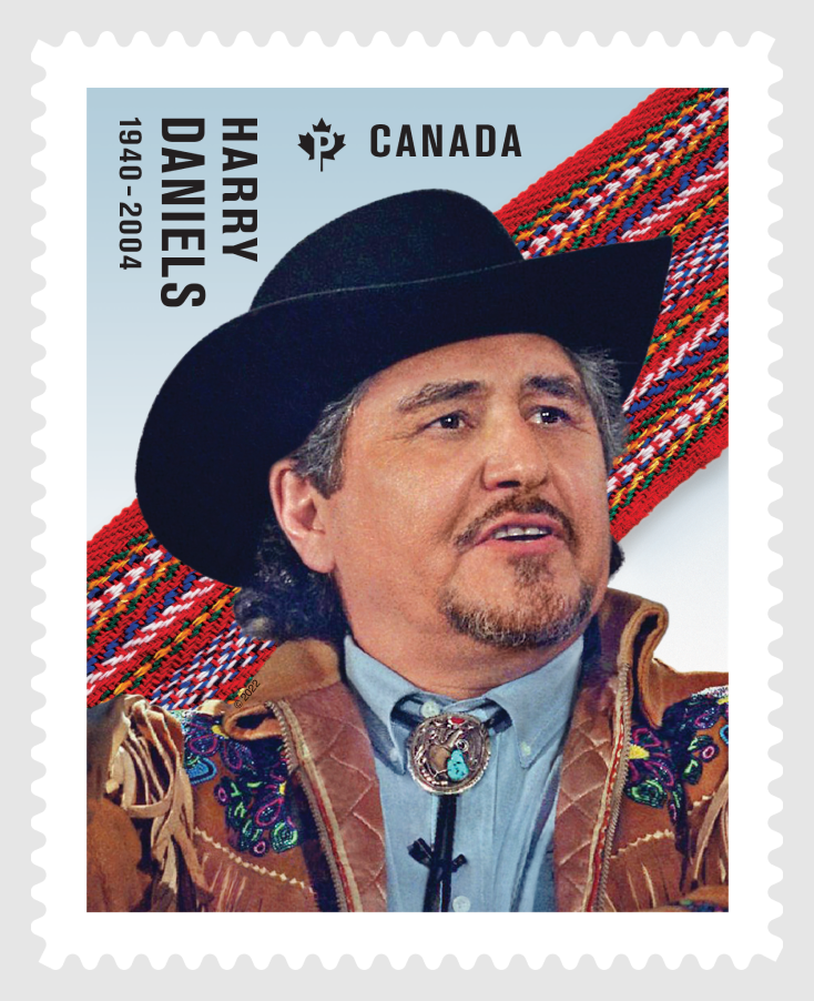 A stamp featuring Metis leader Harry Daniels. He wears a black wide-brimmed hat and a brown suede leather jacket embellished with colourful beads.