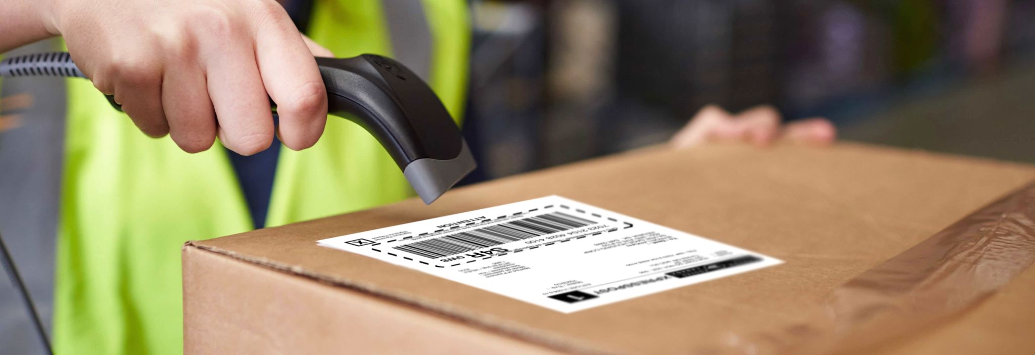 A postal worker scans the Canada Post shipping label on package