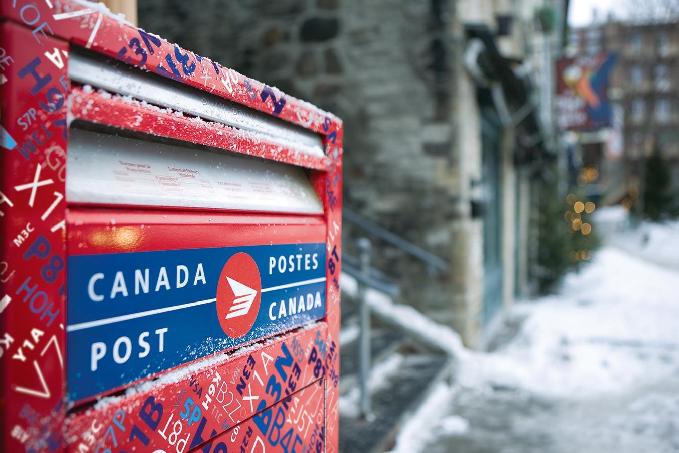 Close-up of a Canada Post mailbox highlighting its drop-off slot