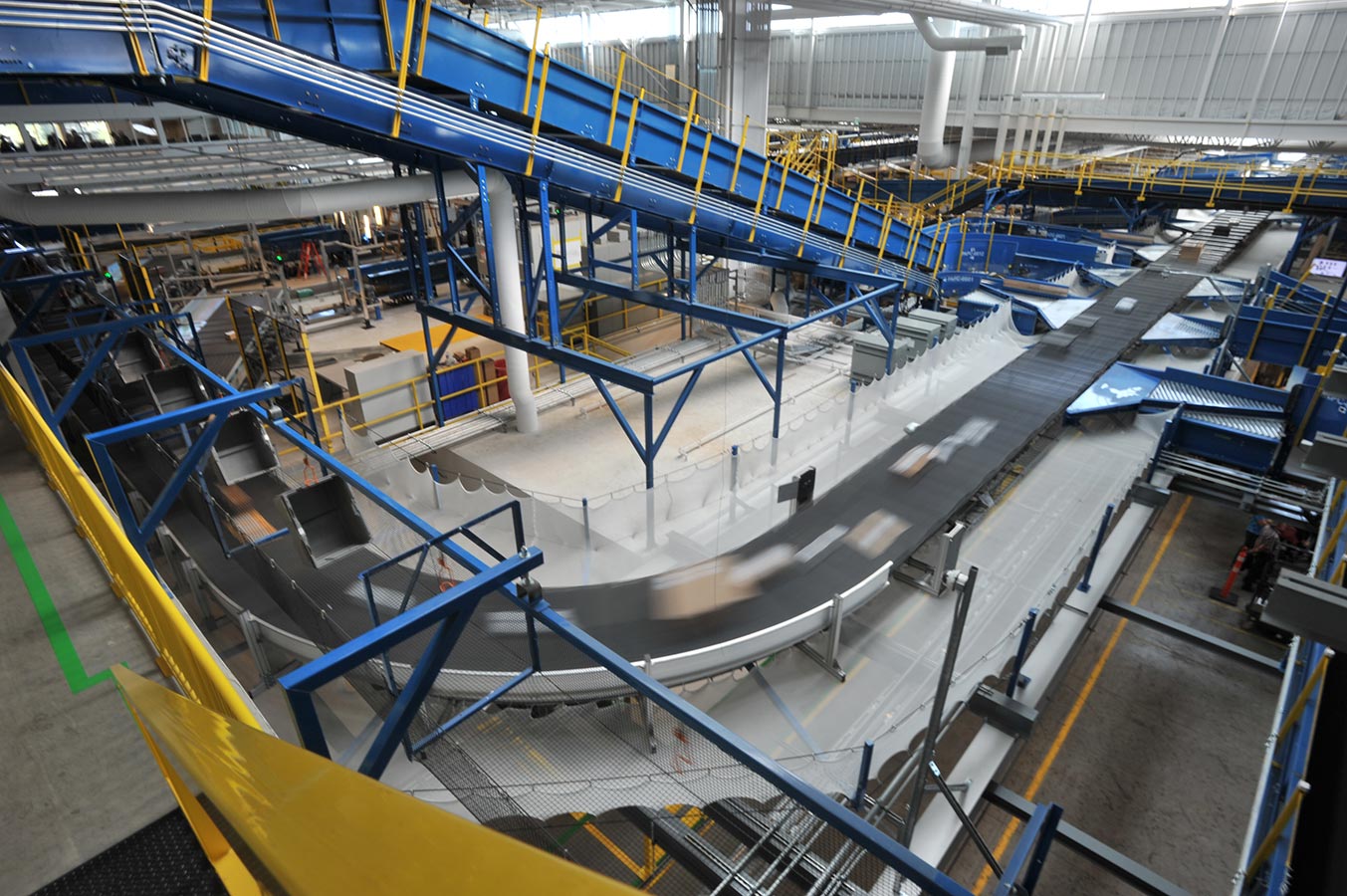 Interior view of a mail processing centre featuring a large conveyor belt