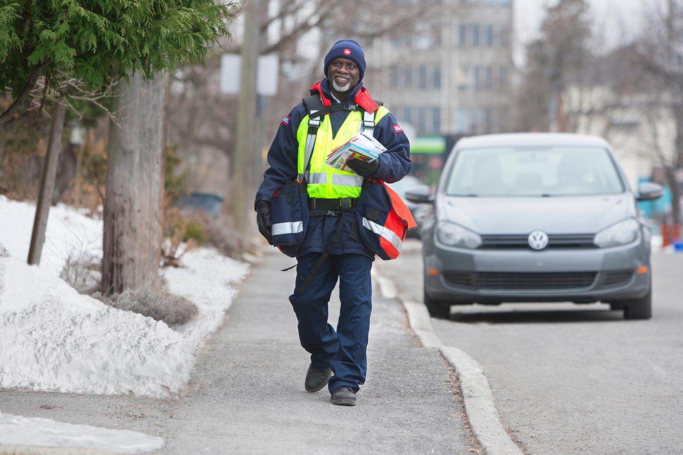 Delivery agent walking along a residential sidewalk