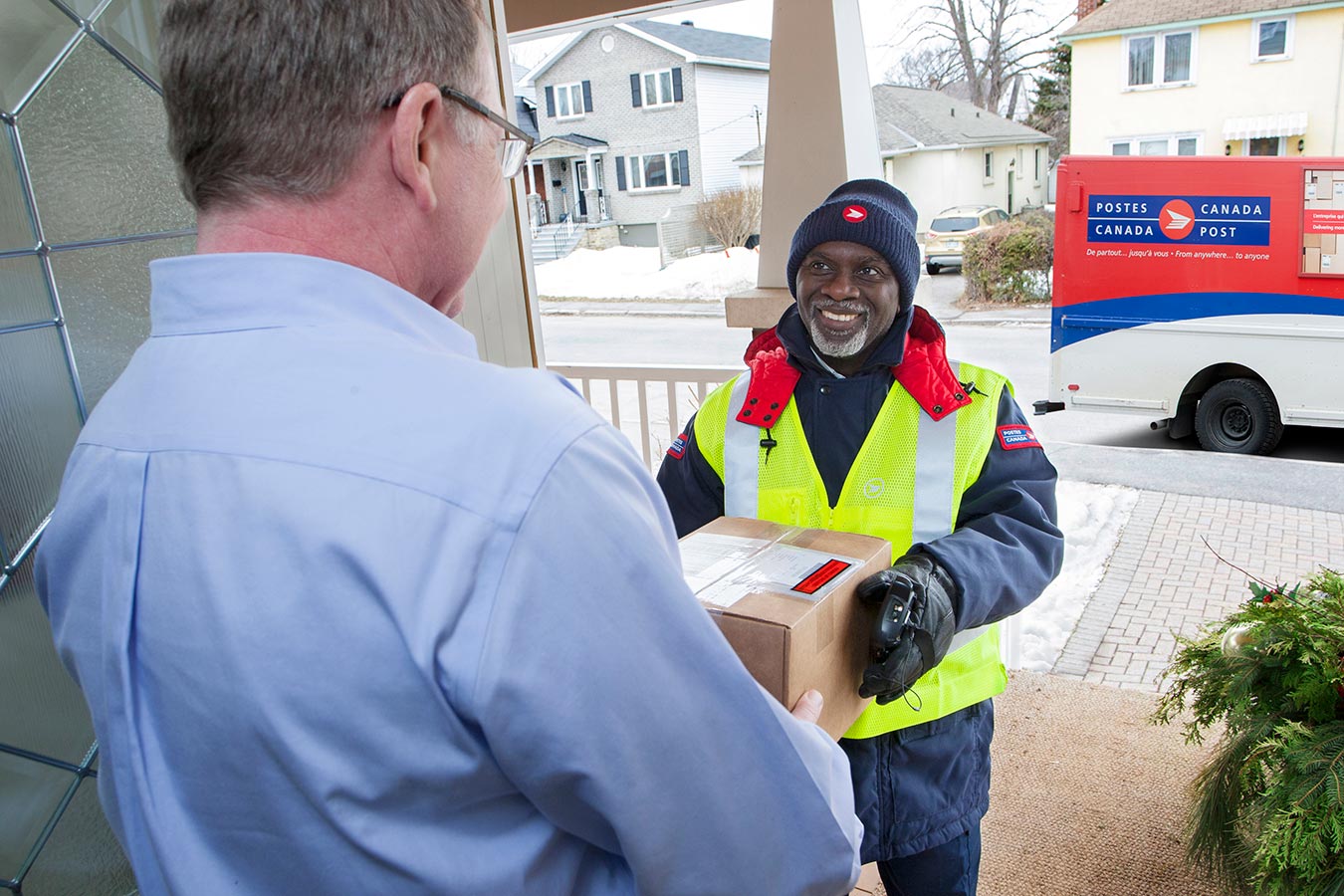 Delivery agent handing a package to a man