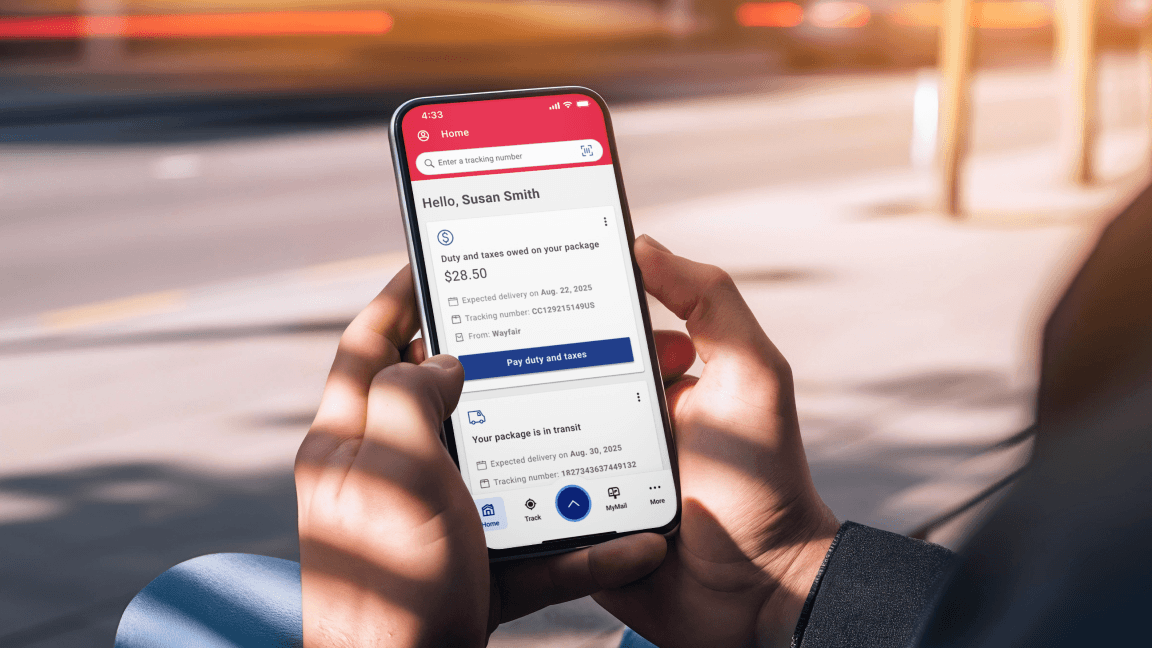 A man holds a smartphone displaying the Home screen of the Canada Post app.