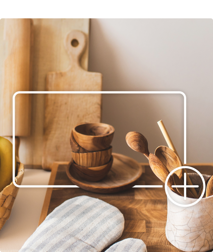 Wood kitchenware on a countertop. Items are outlined by a white box and plus sign graphic that indicates adding to an online shopping cart.