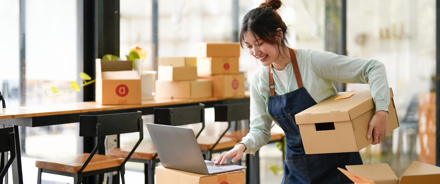 Woman applies a Canada Post return label to a package