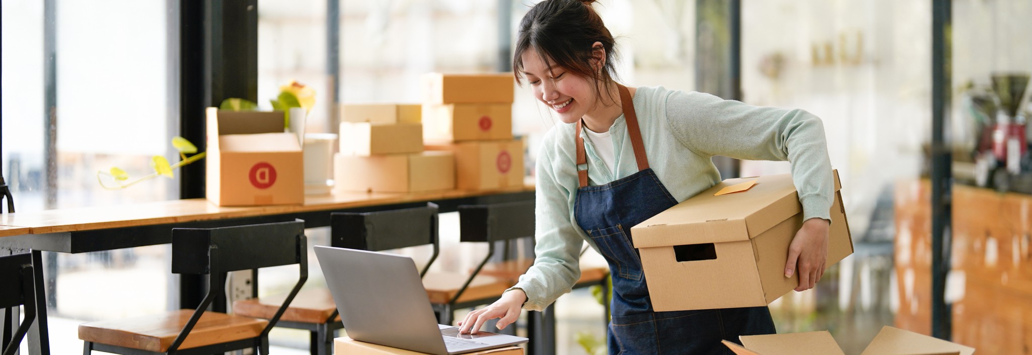 Woman applies a Canada Post return label to a package