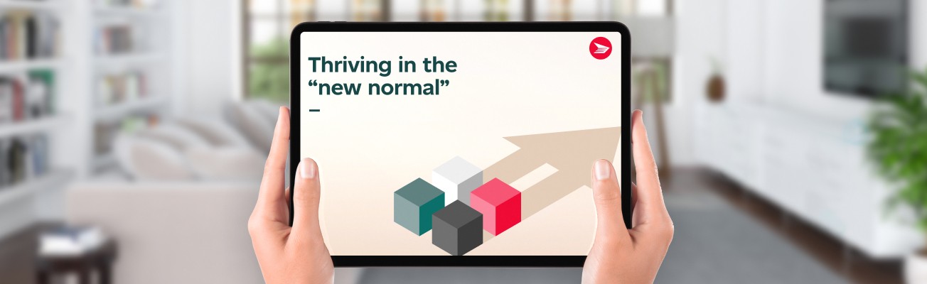 A person holds a tablet computer that displays the cover of the “Thriving in the new normal” report.