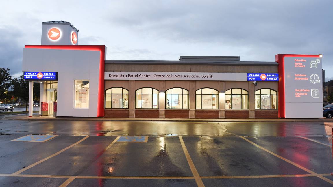 L’extérieur d’un nouvel emplacement de Postes Canada doté d’un centre-colis avec service au volant. L’extérieur d’un nouvel emplacement de Postes Canada doté d’un centre-colis avec service au volant.